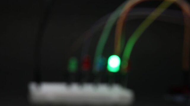 Blurred background with LED lights blinking on the background showing the concept of breadboard electronics and the prototyping