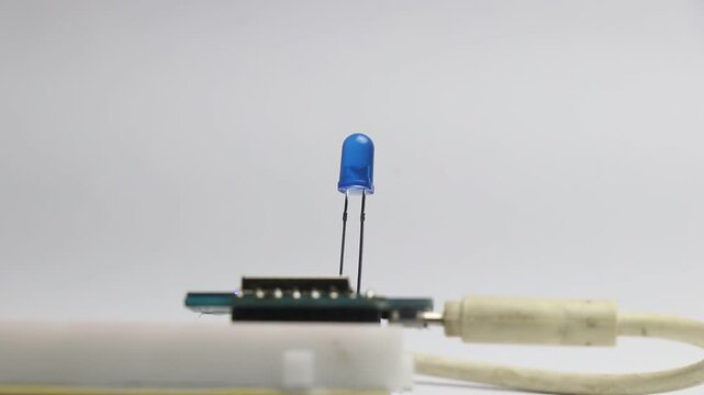 Blue colored led blinking light that is controlled by a micro controller and connected on a breadboard