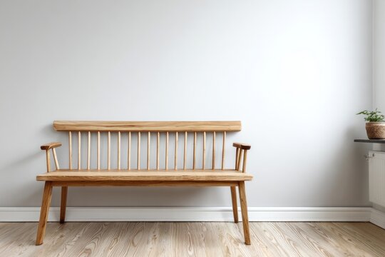 Natural wooden spindle back bench sits against a light gray interior wall above a wooden floor