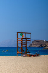 View of a lifeguard tower at the Sandy Mylopotas beach in Ios Greece