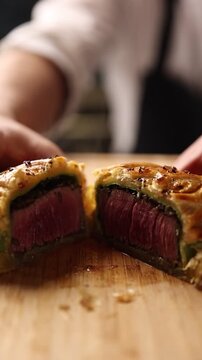 The cook prepares a steak in the kitchen.