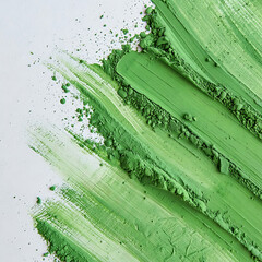 Vibrant green paint strokes and splatters on a white background isolated on white background