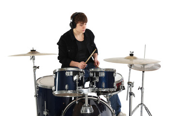 Teenage boy in headphones with drumsticks learning how to play drums on white background