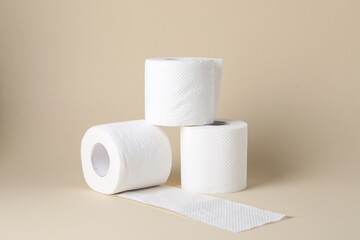 Rolls of toilet paper on beige background