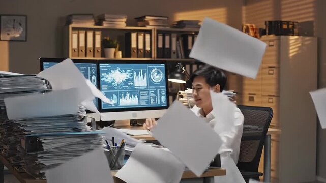 Overwhelmed person throwing documents in office showing frustration with work