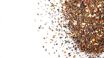 Naklejka premium A loose leaf tea blend with visible spices and dried fruit pieces is scattered across a bright white surface creating a textured pattern on the right side.