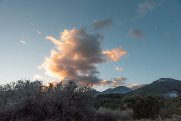 Mountain range among clouds under the sky