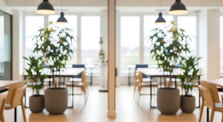 Fototapeta premium Bright office space with large potted plants and wooden chairs under hanging lamps workspace green plants