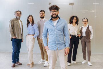 Fototapeta premium Diverse business team comprising men and women of different ages standing in a modern office, working together