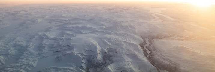 Aerial view snowy mountains landscape winter sunrise © Michael