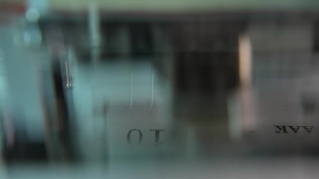 Ink-stamping device used to sequentially mark paper forms. A mechanical manual numerator types ordinal numbers on paper forms. Close up