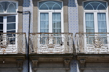 Traditional architecture in Porto: small balconies and facade of distinctive blue and white azulejo. Location: Porto Portugal