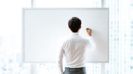 真っさらなホワイトボードに向かうビジネスマン
