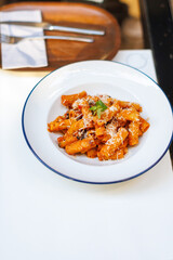 Delicious salmon pasta dish served on a white plate in a casual dining setting