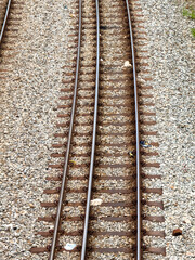 Fototapeta premium A close-up view of train tracks on a gravel surface