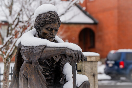 Snow Covered Frederick Douglass Bronze Statue in Winter in Urban Park