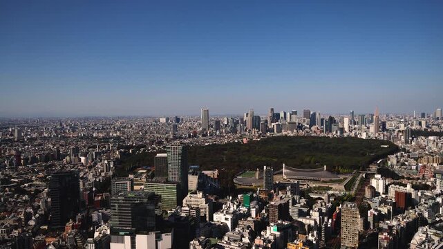 Tokyo, Japan, beautiful super wide aerial view of rooftops and skyscrapers, with skyline and city wards scenery, from the observation deck in a sunny day with a blue sky, Tokyo Metropolitan urban area