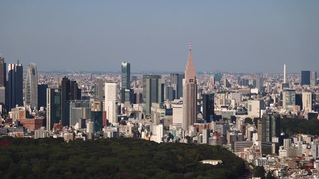 Tokyo, Japan, beautiful super wide aerial view of rooftops and skyscrapers, with skyline and city wards scenery, from the observation deck in a sunny day with a blue sky, Tokyo Metropolitan urban area