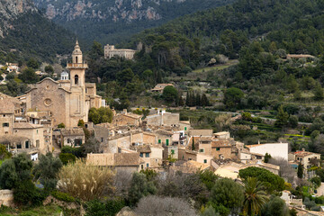 Obraz premium Panoramic view of the mountain village of Valldemossa with church Sant Bartomeu in Serra de Tramuntana mountains, Mallorca, Balearic Islands, Spain