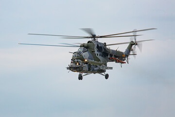 Fototapeta premium Military combat helicopter in mid-air flight