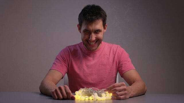Demonstration of Garland Lights in Use. Showing How Battery Controller Turns On String Lights. Detailed View of Hand Operation and Bulb Transition for Ambient Decoration