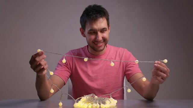 Demonstration of Garland Lights in Use. Showing How Battery Controller Turns On String Lights. Detailed View of Hand Operation and Bulb Transition for Ambient Decoration