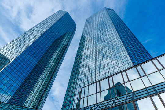 Vertical architectural photography of glass high-rise buildings headquarters with reflections in the financial district