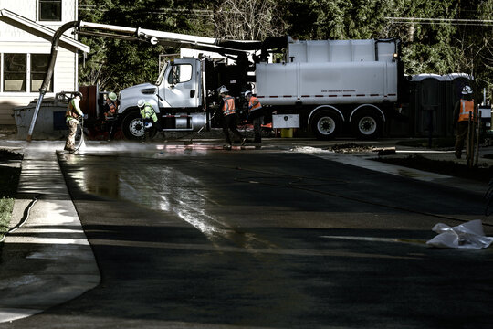 Specialized hazardous materials response team, hazmat cleanup of spilled chemicals on residential housing development job site, Vacuum Excavator truck and workmen with equipment
