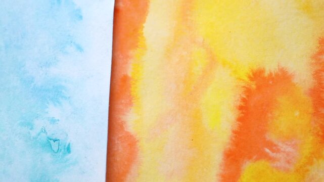 Abstract watercolor paintings on canvas, top view. Camera moving right