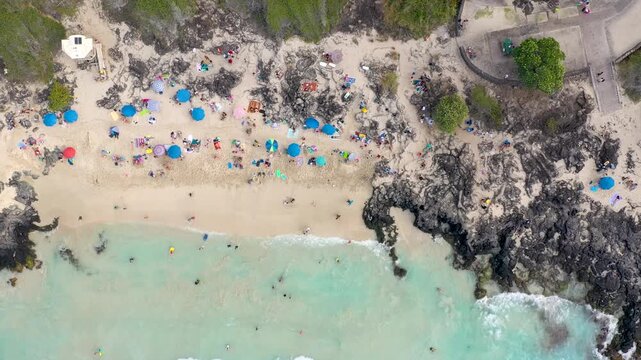 Aerial Top Down View of Turquoise Lagoon Meeting Volcanic Lava Rock Coastline, Big Island Hawaii