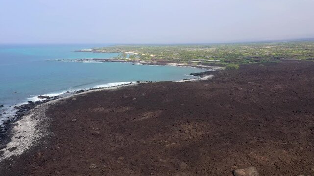Aerial View of Volcanic Lava Fields Transitioning to Lush Green Neighborhood, Big Island Hawaii
