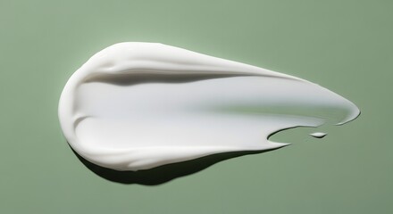 Fototapeta premium Cream flowing on green surface, captured overhead