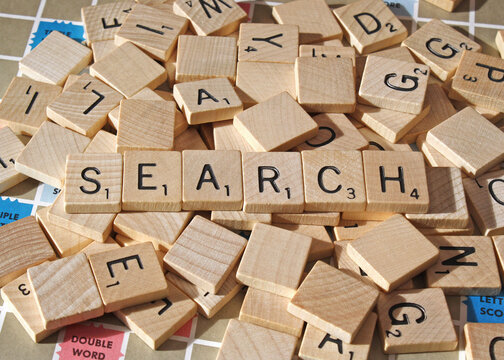 Vintage wooden scrabble tiles laid out on game board. The word SEARCH can be seen amongst the tiles.  Photo taken in Ontario Canada January 31, 2026