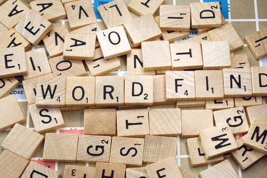 Vintage wooden scrabble tiles laid out on game board. The words WORD and FIND can be seen amongst the tiles.  Photo taken in Ontario Canada January 31, 2026