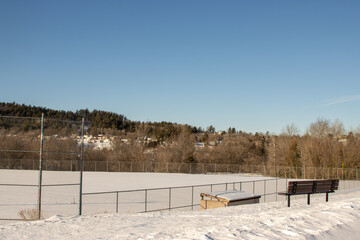 A snow-covered baseball field in winter