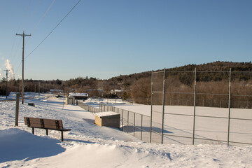 A snow-covered baseball field in winter