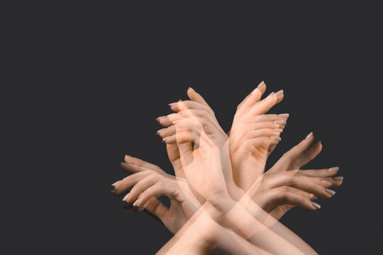Stroboscopic photo of moving female hands on dark background