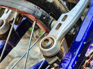 Close-up Detail of Bicycle V-Brake System on Blue Frame with Rusty Texture