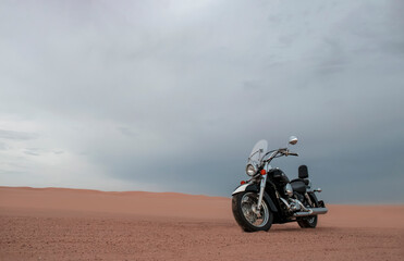 Fototapeta premium A motorcycle rests beneath a vibrant sunset sky, evoking freedom, adventure, and independence, symbolizing open roads, personal journeys, and the endless desire to explore new horizons.