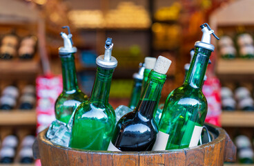 glass bottles of wine in ice frozen wooden barrel for tasting and winter cold drink to alcohol beverage with fruit or celebration party with winery stock or store shelf background for sale