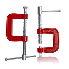 Two red c-clamps stand side-by-side against a bright white background with soft shadows & subtle reflection