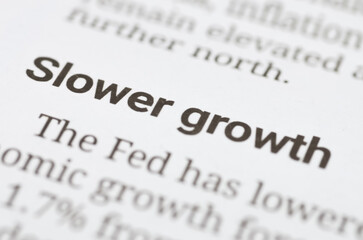 Close-Up of Financial Newspaper Highlighting 'Slower Growth' Headline and Economic Forecast Commentary