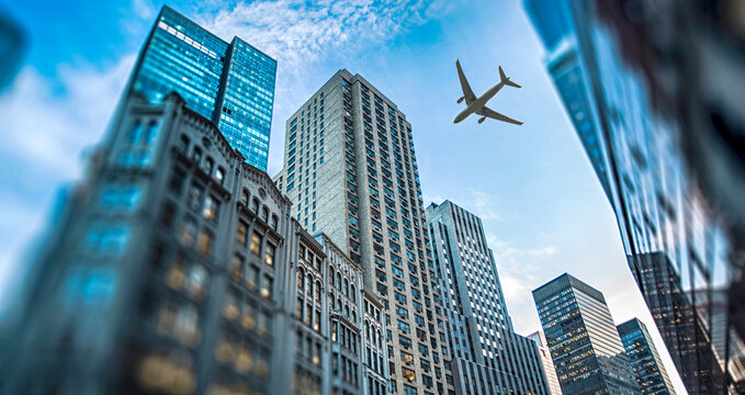 An airplane flies over the skyscrapers of New York.