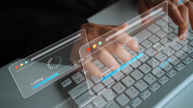 Hands Typing on Keyboard with Digital Interfaces Displaying Loading Progress Bars in a Modern Workspace Setting Gluon.