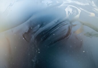 Fototapeta premium Abstract closeup of dark blue and white swirling liquid or ice texture