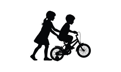 Silhouette of sister helping little brother learn to ride a bicycle outdoor