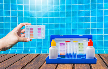 Two type of water tester test kit over clear swimming pool water background, quality water testing test kit, pool maintenance and service business concept