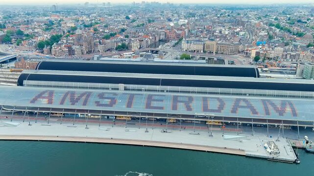 Amsterdam, Netherlands. Amsterdam Central Station. Amsterdam Centraal - The largest train station in the city, built in 1889. Bay IJ (Amsterdam). Drone footage, Point of interest, Point of interest