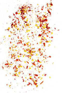 Close up spicy chili red pepper flakes, chopped, milled dry paprika pile isolated on white