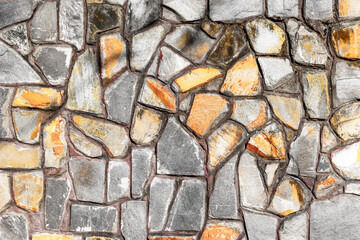 Textured stone wall with varied shapes and earthy tones
